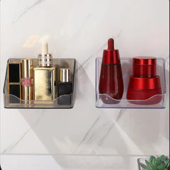 Mirrored Cabinet Organizer Bin - Two clear plastic wall-mounted storage organizers holding cosmetics, mounted on a white marble-patterned wall