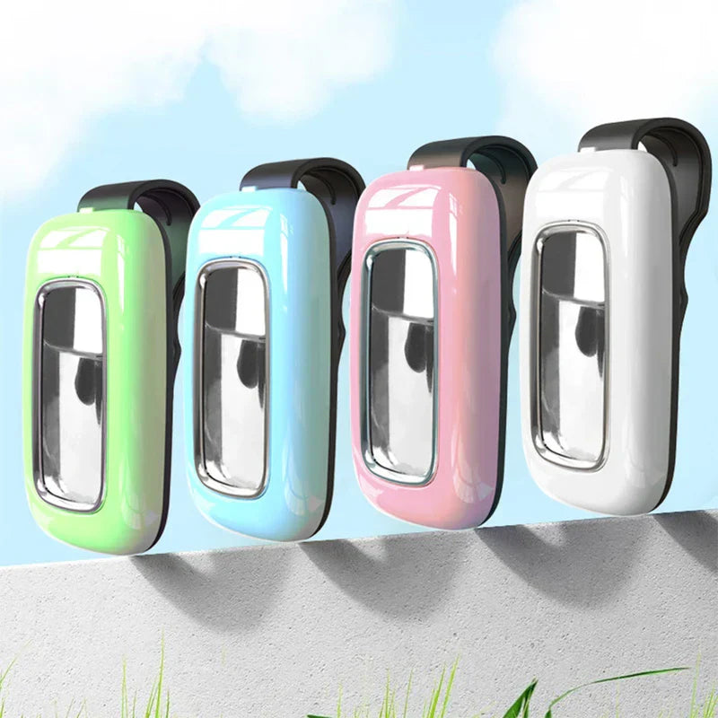 Wearable Mosquito Repellent - Four clip-on devices in green, light blue, pink, and white lined up on a concrete ledge