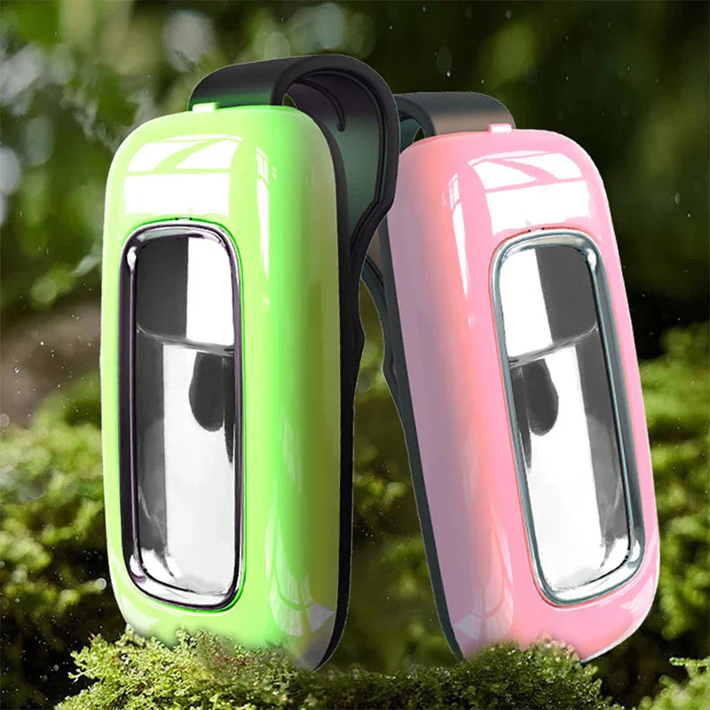 Wearable Mosquito Repellent - Neon green and pink key fob covers standing side by side on moss, with green foliage in the background