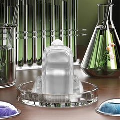 Wearable Mosquito Repellent - Translucent single-use packet standing upright in a glass petri dish among laboratory glassware