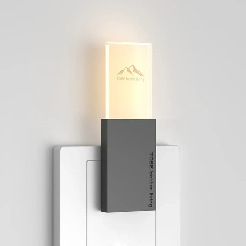 Mosquito Repellent Night Light - Lit wall-mounted small light fixture with gray base and glowing upper panel against a white wall