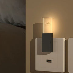 Mosquito Repellent Night Light - Plug-in lamp installed in a wall electrical outlet next to a bed, casting warm soft glow