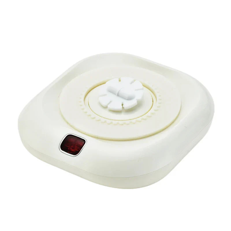 posavasos individual - Unidad cuadrada en blanco roto con luz indicadora roja y dial central giratorio, mostrada sobre un fondo blanco liso