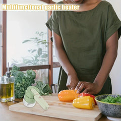Vegetable Slicer - The handheld chopper sits on a wooden cutting board beside fresh vegetables, with a person preparing peppers behind it.