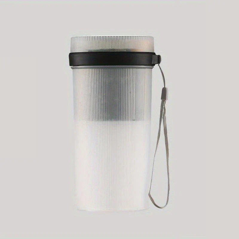 Frosted vertical-ribbed portable juicer blender with a black lid ring and gray wrist lanyard, on a light gray background
