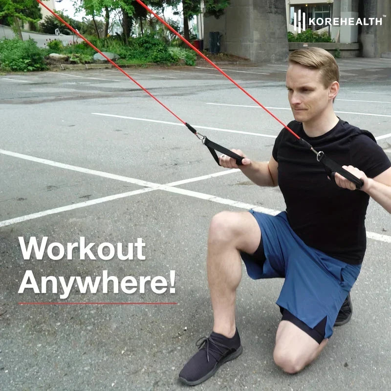 Resistance Band Set - Man in black shirt and blue shorts kneels outdoors while holding red resistance bands in a lunge position.