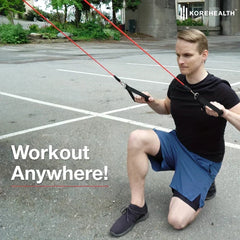 Resistance Band Set - Man in black shirt and blue shorts kneels outdoors while holding red resistance bands in a lunge position.