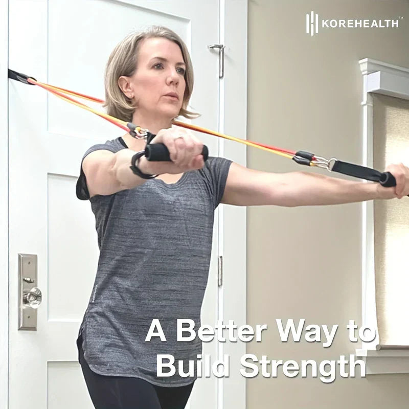 Resistance Band Set - Woman with short gray hair uses resistance bands anchored to a door while performing a chest press exercise.