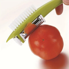 Serrated Vegetable Peeler - Green-handled peeler removing skin from a red tomato, held by a finger