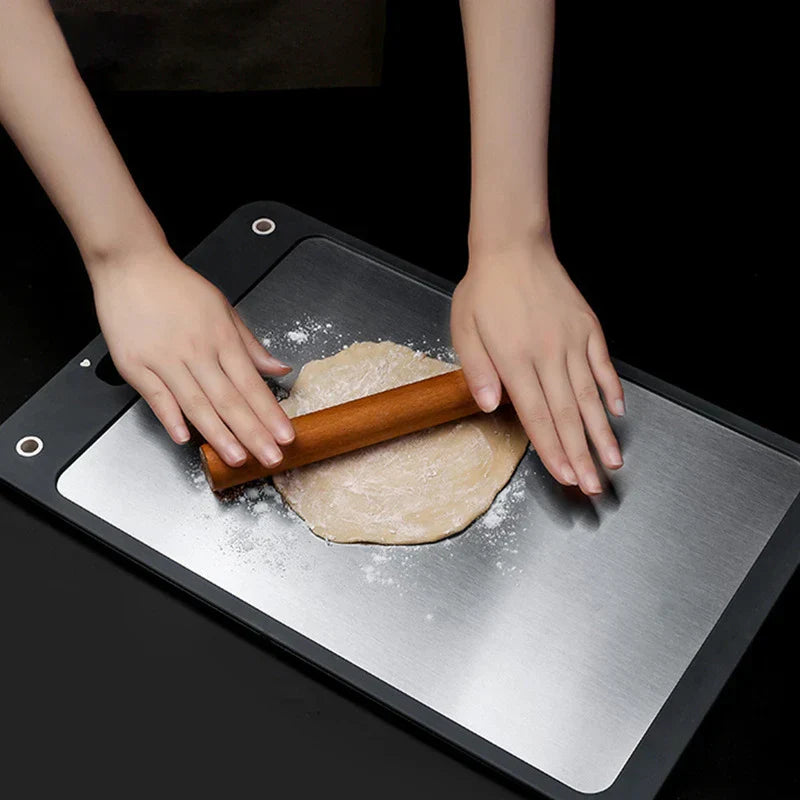 Stainless Steel Cutting Board - Person rolling dough with a wooden rolling pin on the stainless steel side of the same style cutting board