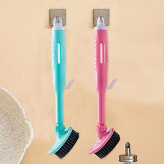 Kitchen Cleaning Brush - Two long-handled kitchen brushes (one turquoise, one pink) with black bristles hang from adhesive wall hooks.