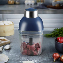 Smoothie Maker - Blender on kitchen countertop with cubed raw meat inside the clear jar, surrounded by fresh produce and dumpling prep supplies