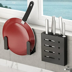 Pot Lid Holder - Black wall-mounted bracket holding a red frying pan next to an adjacent wall knife block on a tiled kitchen wall near a window