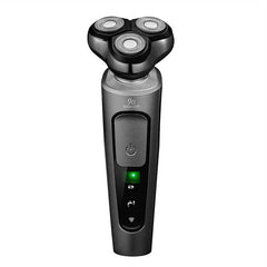 Front view of a silver three-head electric shaver with green status light on a white background