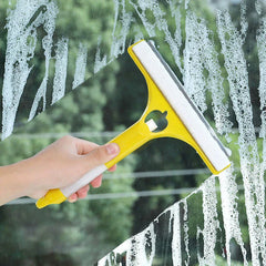 Window Squeegee Cleaner - Hand holding a yellow and white window squeegee wiping suds from a glass surface