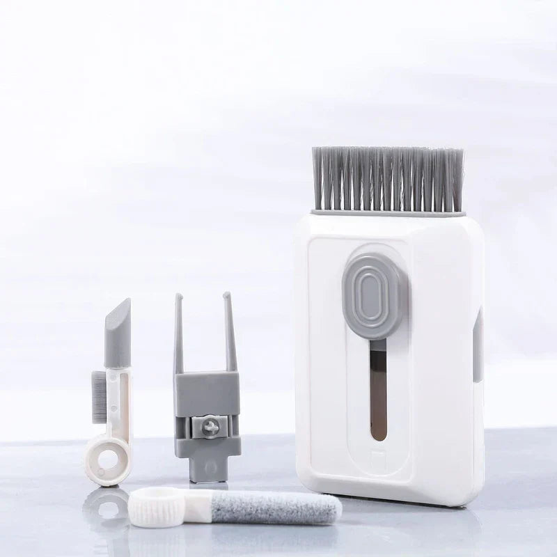 cleaning brush set with interchangeable heads laid out on a smooth surface