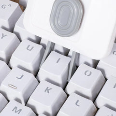Car Cleaning Brush Kit - Cleaning tool with dual prongs positioned between white keyboard keycaps