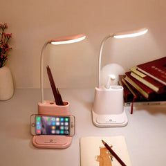 Led Desk Lamp - Pink and white color variants of the desk lamp placed on a desktop, with pens stored in the organizer compartment, next to a stack of books and small decorative vase