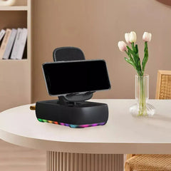 Car Phone Stand Holder - Stand holding a smartphone placed on a round white table, with home decor including a tulip vase and bookshelf in the background