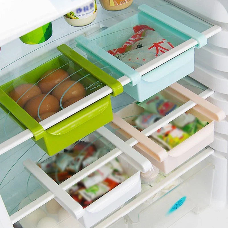 Storage Box Organizer - Multiple colored storage boxes mounted on glass refrigerator shelves, holding eggs and packaged food items.