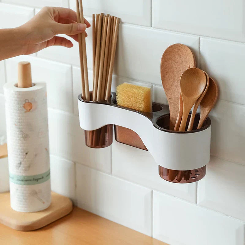 Shelf Organizer - Wall-mounted kitchen utensil holder attached to white subway tile, holding wooden chopsticks, a yellow scrub sponge, and wooden spoons