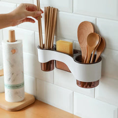 Shelf Organizer - Wall-mounted kitchen utensil holder attached to white subway tile, holding wooden chopsticks, a yellow scrub sponge, and wooden spoons