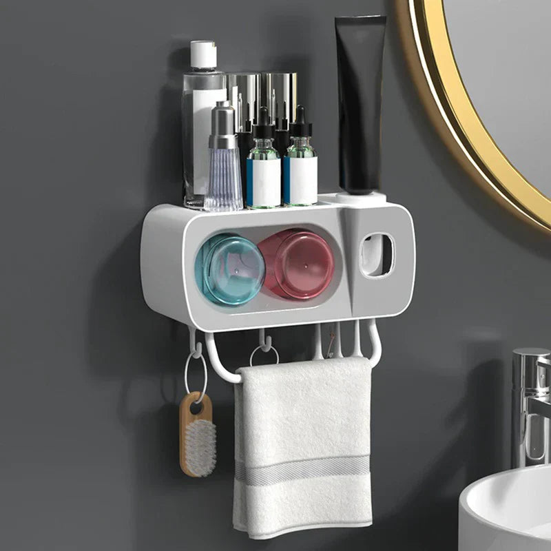 Toothbrush Holder - Installed wall-mounted storage unit holding skincare bottles, toothpaste, with a hand towel and cleaning brush hanging from its lower hooks
