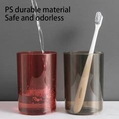 Toothbrush Holder - Two translucent rinse cups, one being filled with water, one holding a manual toothbrush, with text noting durable PS material