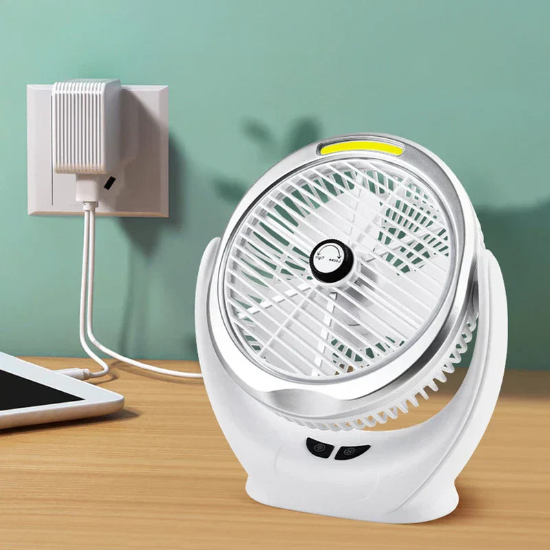 Desk Fan - White desktop fan plugged into a wall outlet with a white USB charger, partial tablet on a wooden table against a teal wall