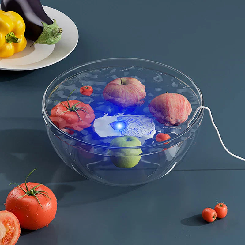 Ultrasonic Cleaner Machine - A clear glass bowl of water with fruits, a blue-lit white device inside, and a white cord extending out