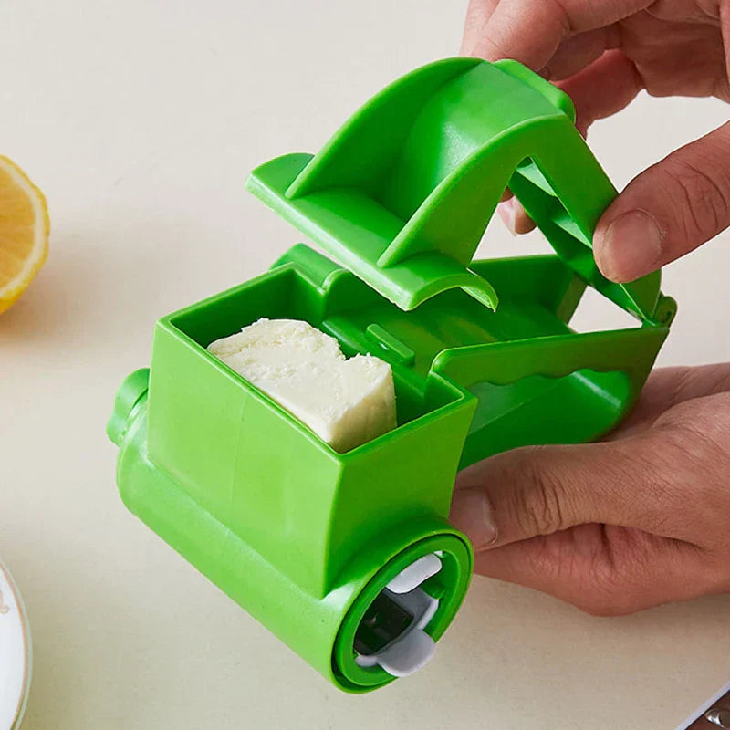 Vegetable Grater - Hands hold open a green rotary grater, with a block of butter placed inside its open compartment.
