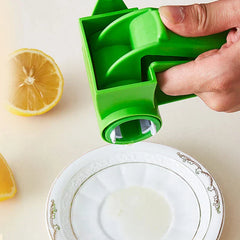 Vegetable Grater - Hand holding the rotary tool over a decorative white plate, with fresh lemon slices placed on the adjacent countertop