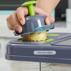 Vegetable Slicer - Hand using safety food holder to press a potato against the slicing blade