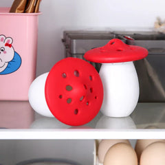 Mini Fridge And Wine Cooler - Two mushroom-shaped objects with red caps and white bases resting on a glass shelf, one upright and one tipped over.