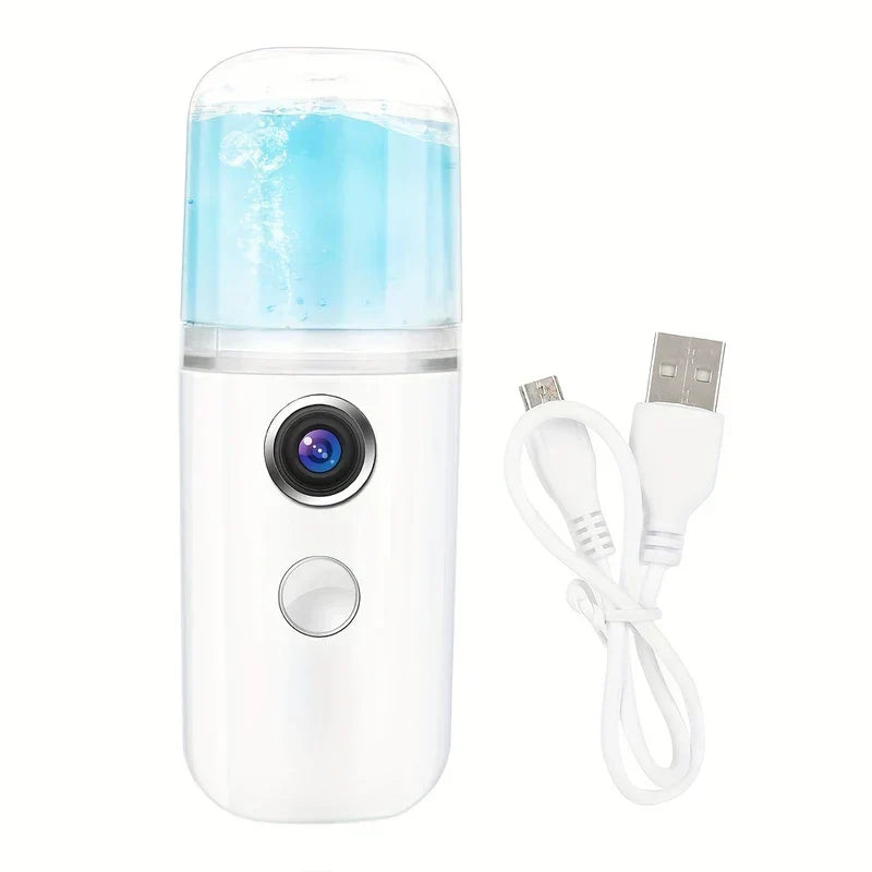 Nano Facial Mist Sprayer - White portable nano mist sprayer with blue liquid in transparent tank and white Micro USB charging cable on plain white background
