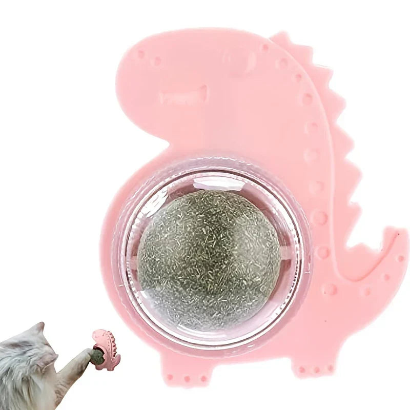 Natural Catnip Ball Wall Lollipop Toy - Pink dinosaur-shaped mounted cat toy with textured green catnip ball, inset of cat reaching for matching small toy