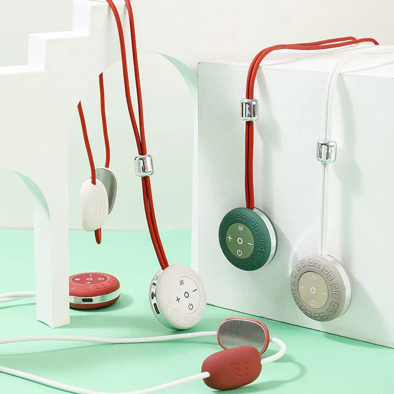 Shiatsu Massager Pillow - Multiple pendant-style neck massagers in red, off-white, dark green, and light gray arranged on a mint green surface with white display stands