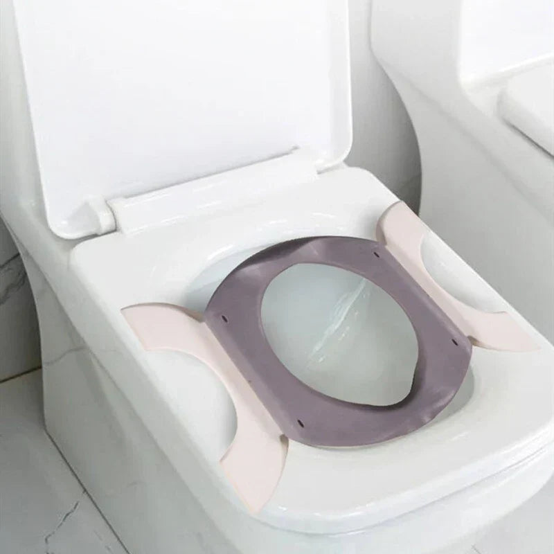 Folding Travel Potty - Unfolded potty seat placed securely on top of a standard white adult toilet