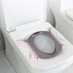 Folding Travel Potty - Unfolded potty seat placed securely on top of a standard white adult toilet