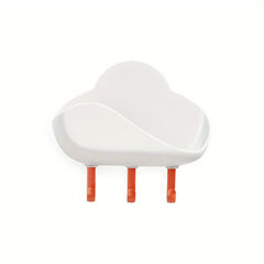 Cloud Wall Hooks - White adhesive wall-mounted storage unit with three orange hanging pegs, curved open top shelf
