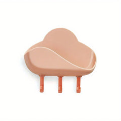 Cloud Wall Hooks - Dusty peach cloud-shaped wall mounted storage shelf with three terracotta hooks against white background
