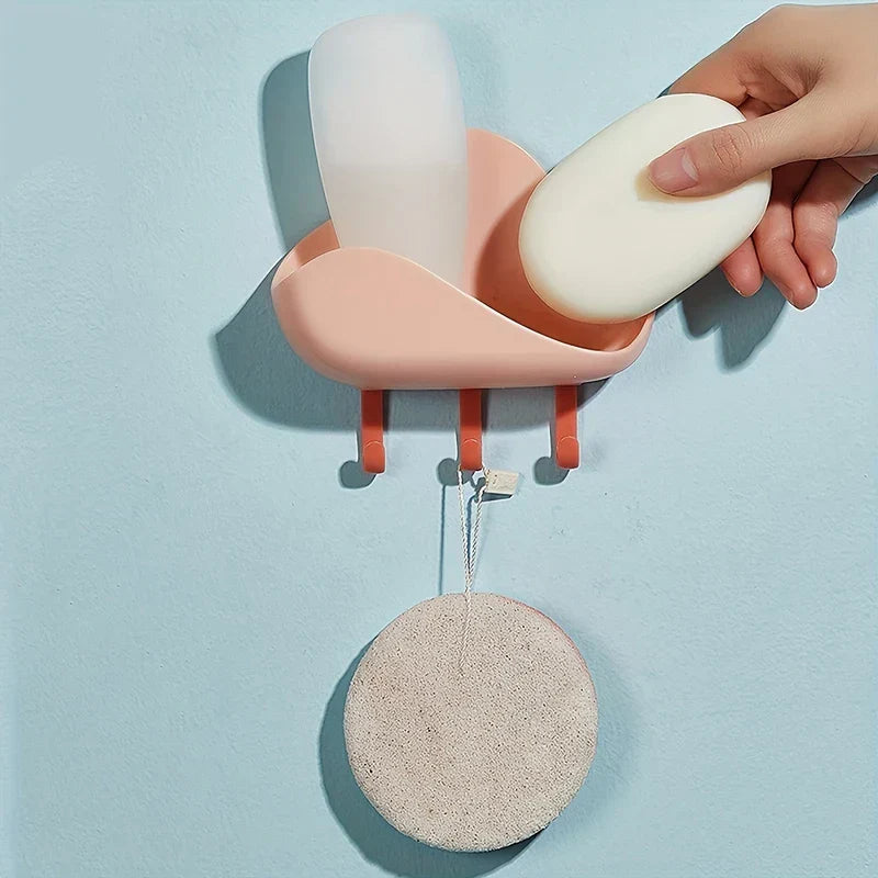 Cloud Wall Hooks - Wall-mounted pink cloud soap holder holding soap and a bottle, with a scrub pad hanging from one hook