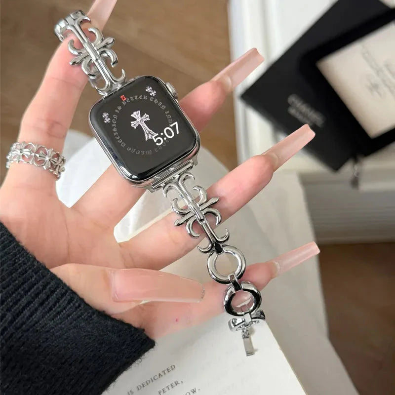 Polished silver gothic cross apple watch band fitted to an Apple Watch, displayed on an outstretched hand