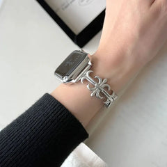Close-up of a silver-toned decorative apple watch band worn on a wrist with a smartwatch