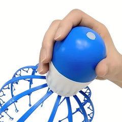 Head Scalp Massager - Close-up of a hand pressing the power button on the top of the octopus-shaped vibrating relaxation tool