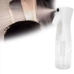 Oil Sprayer - White spray bottle emitting a fine mist of liquid toward hair.
