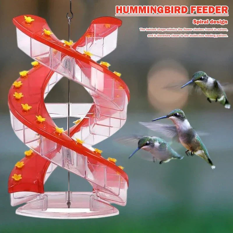 Hanging Bird Feeder - Spiral red and clear hanging hummingbird feeder with three hummingbirds in flight nearby.