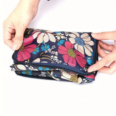 Travel Backpack - Two hands hold a folded, zippered dark floral fabric pouch against a white background.