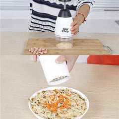 Garlic Mincer - Split view: the chopper holds chopped nuts above a cutting board, and pours chopped ingredients onto a noodle dish.