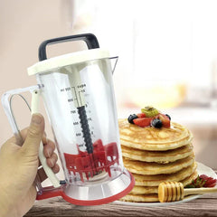 Pancake Batter Dispenser - Hand holding clear measured dispenser next to a stacked plate of topped cooked pancakes
